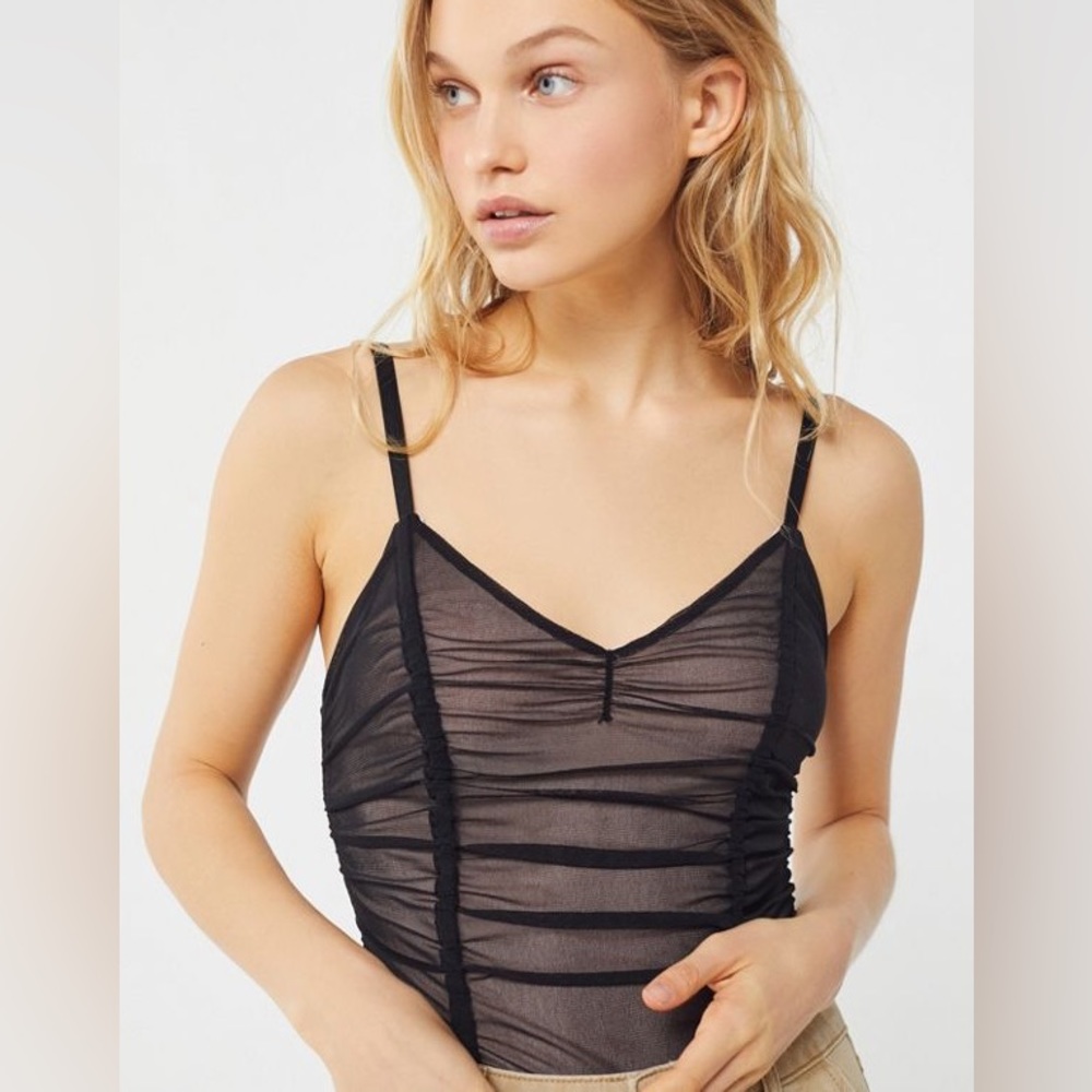 Out from under black mesh body suit